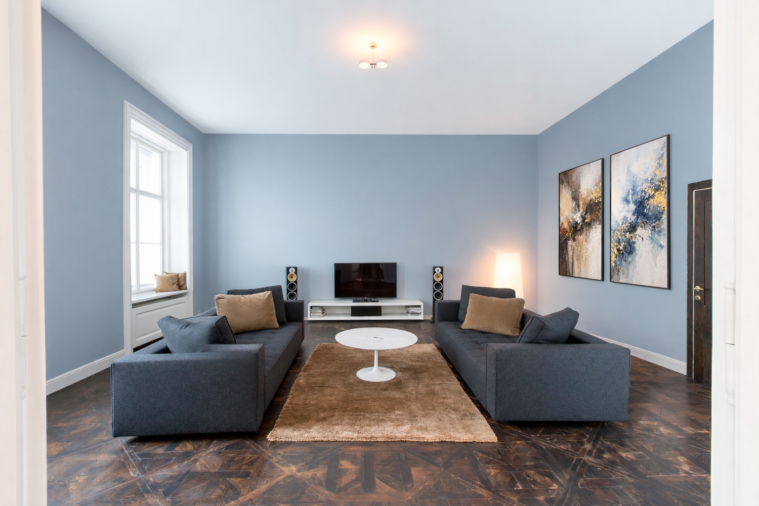 Open living and dining room with sofas and fruit bowl